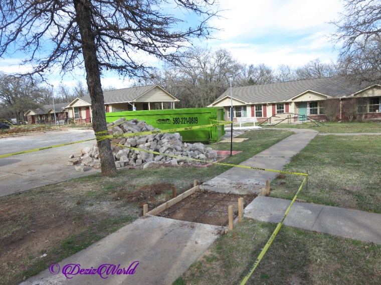 Pile of rubble that was parking lot and sidewalk